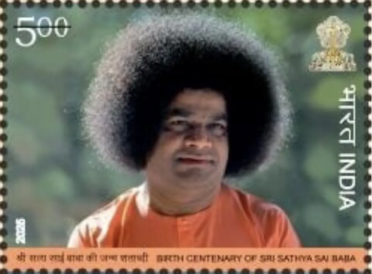 Indian postage stamp issued in 2025 depicting Sathya Sai Baba in an orange robe against a green background, commemorating his birth centenary