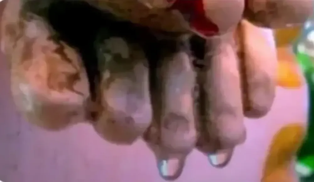 Close-up of water beads at the crucifix feet—leak exit point