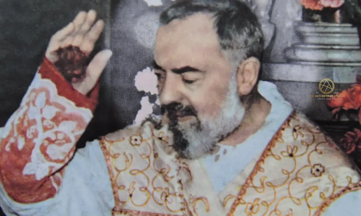 Padre Pio in ornate vestments raising his right hand, bandaged stigmata visible; colorized archival photograph.