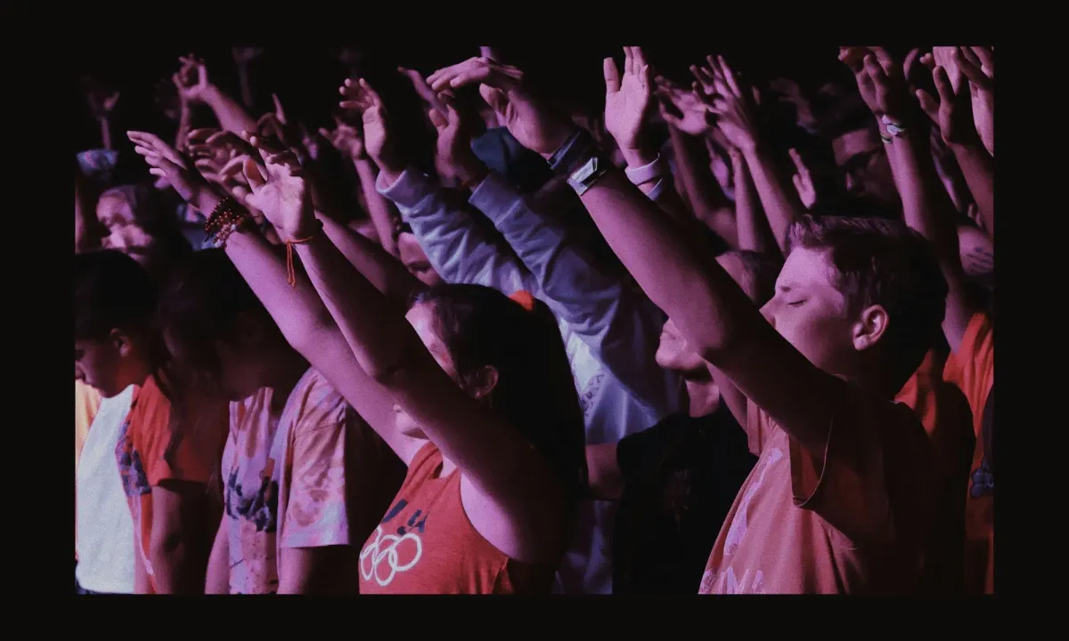 Congregation with raised hands during a modern evangelical worship service